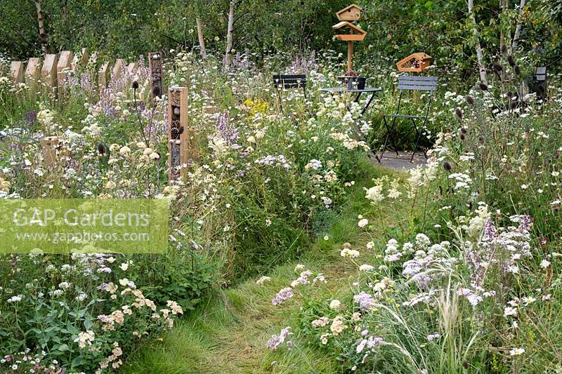 Bug box and overgrown flower borders in the BBC Springwatch garden at RHS Hampton Court Flower Show 2019 - Designed by Jo Thompson in consultation with wildlife gardener Kate Bradbury