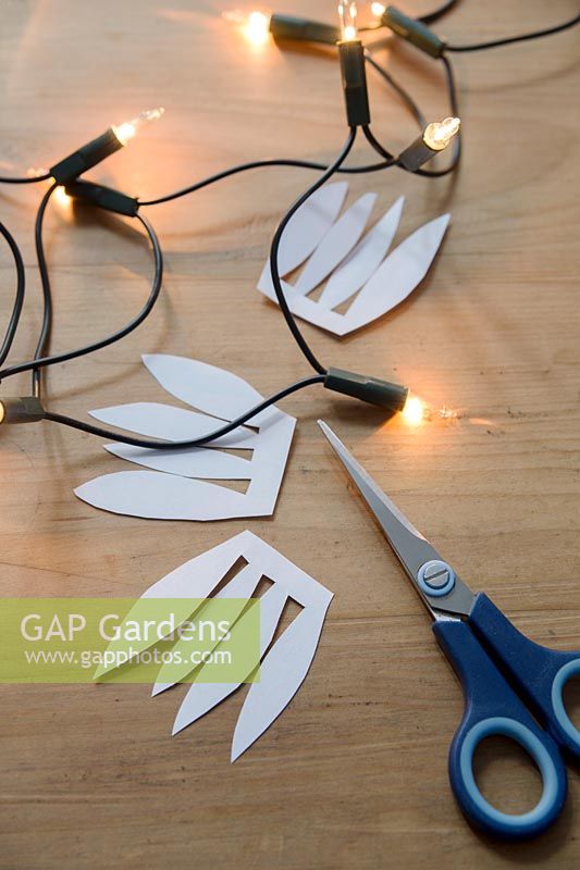 With scissors cut a freehand shape with 4 petals on it to make the base for the decorative bulb