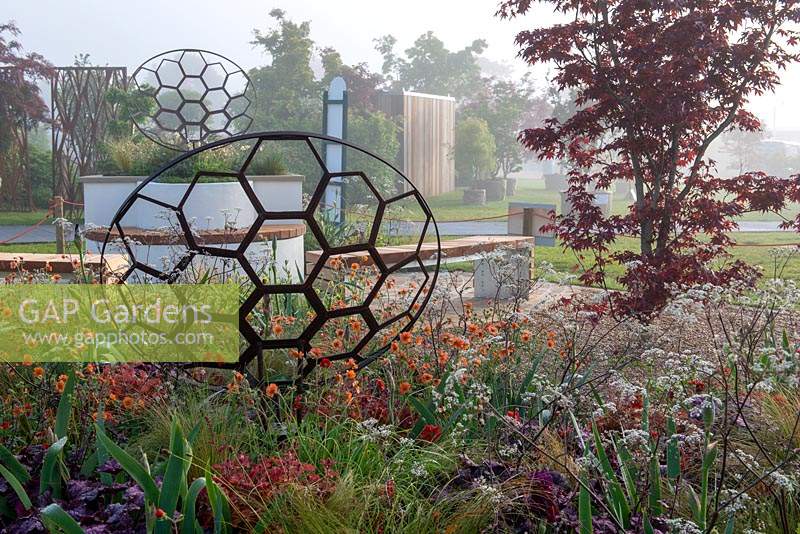 Rusted metal sculpture by Julie Grose Metal Design in a mixed border   - The Redshift, RHS Malvern Spring Festival 2019