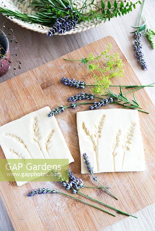 Salt dough with impressions of lavender flowers pressed into individual tile shapes 