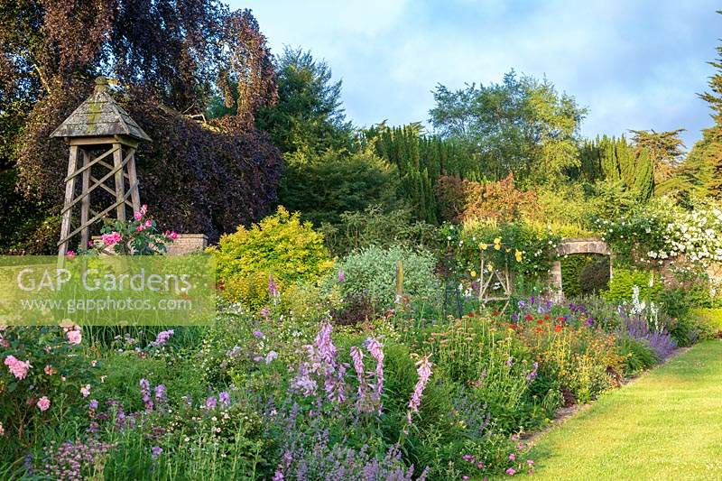 Large double Large summer borders overflowing with summer planting at Miserden Park, Gloucestershire