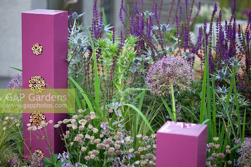 Towering pink insect hotels in the Contemporary Bee and Butterfly Garden at BBC Gardener's World Live 2017