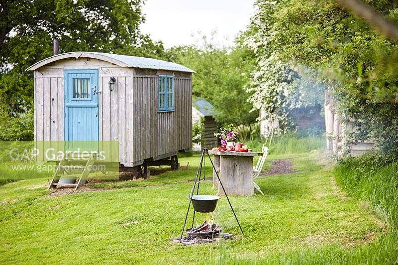 View to shepherds hut, outside dining area and cooking facility all set in Wild Meadows.