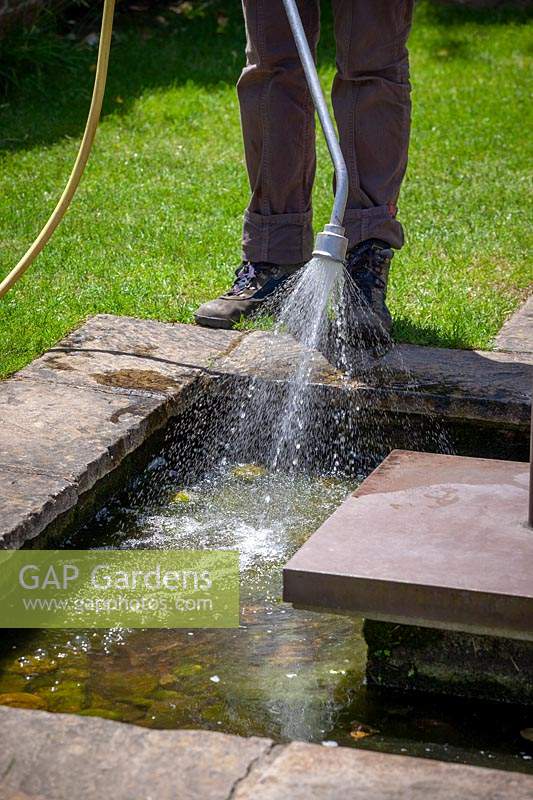 Topping up a water feature using a hosepipe
