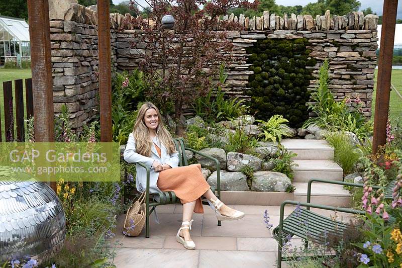 Emily Barnes, Designer, sitting in her 'Elements of Sheffield' garden at the RHS Chatsworth Flower Show 2019.