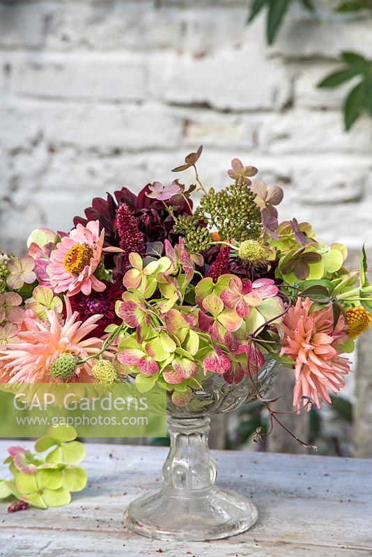 Autumn floral arrangement with Dahlias, Zinnias and Hydrangea in glass bowl