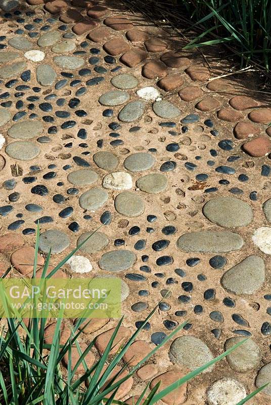 Decorative concrete path with embeded pebbles and stones 