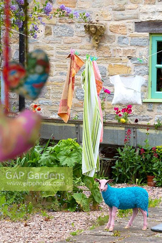 A quirky sheep ornament standing next to the washing line.