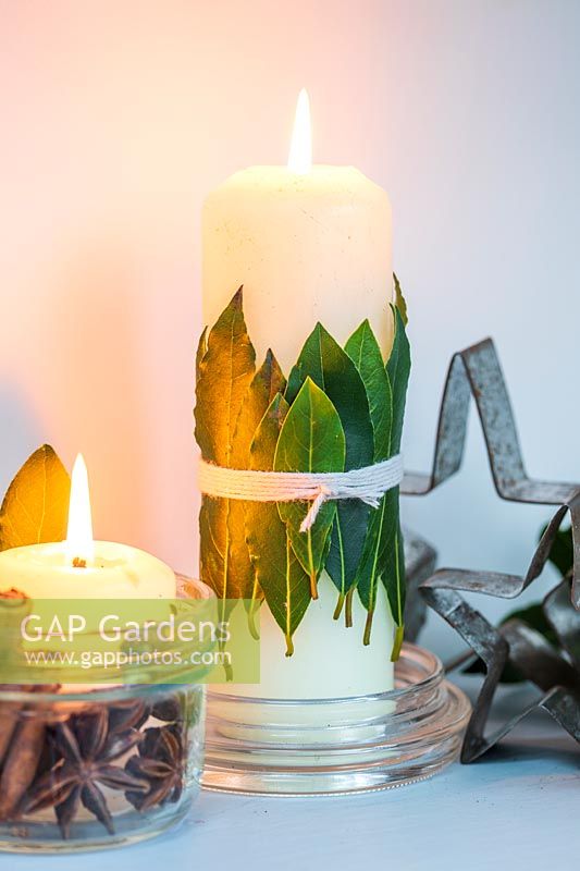Candle decorated with bay leaves 