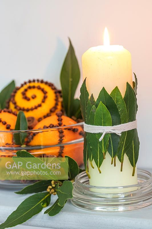 Candle decorated with bay leaves 