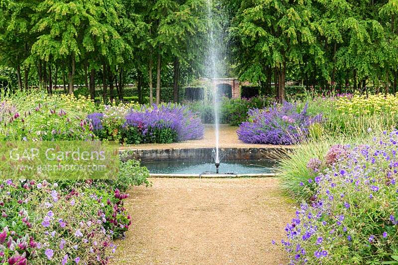 The Perennial Meadow with fountain at Scampston Hall Walled Garden, North Yorkshire, UK.

