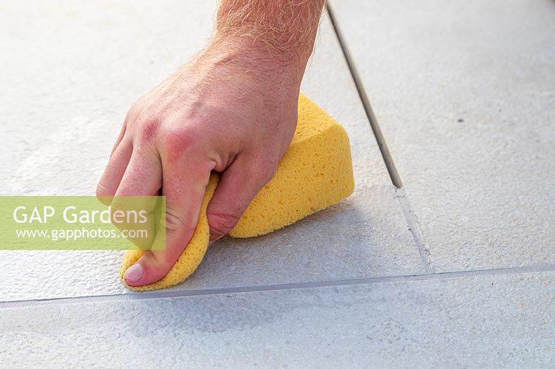 Using a sponge to clean freshly grouted context Porcelain patio