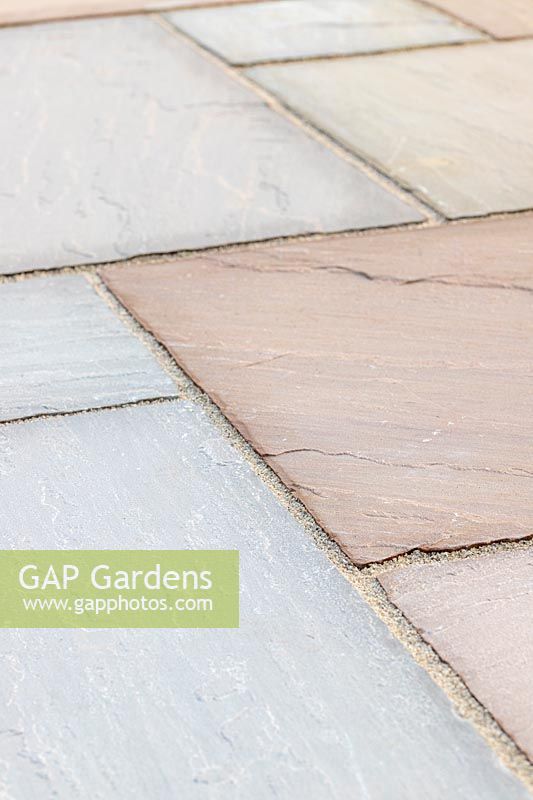 Close up detail of riven sandstone paving in 'Country Green' colour scheme