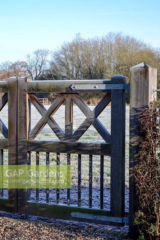 Wooden gate in the early morning frost.