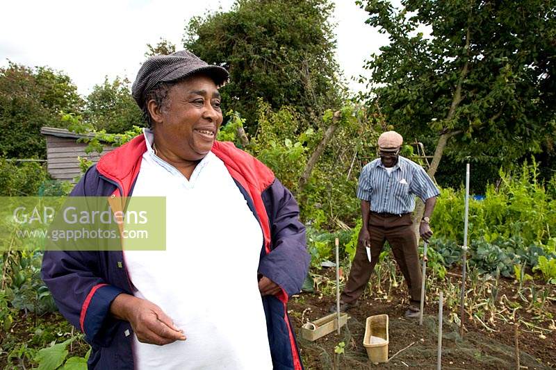 Plot holders share a joke together on the allotment