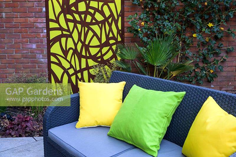 Cushions on sofa with Decorative Mural in Small Modern Garden 
