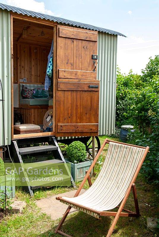 Shepherd's hut used as a garden retreat, view of wooden steps up to open stable door with view of interior  - Open Gardens Day, Friston, Suffolk