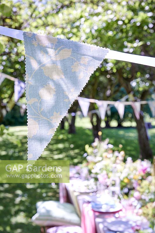 Homemade bunting with triangles of fabric glued to ribbon