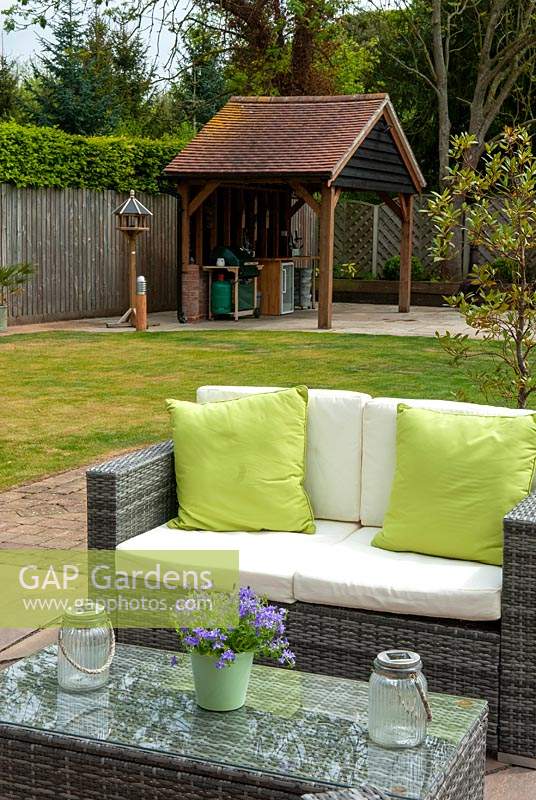 Rattan sofa and table on patio with outside kitchen beyond - Open Gardens Day, Nacton, Suffolk
