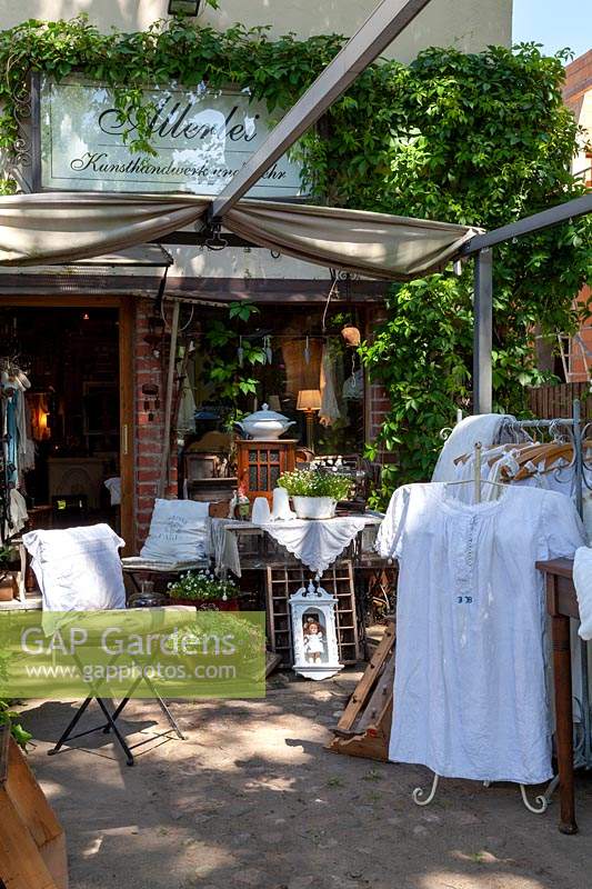 Store with vintage garden furniture and handicrafts outside in summer