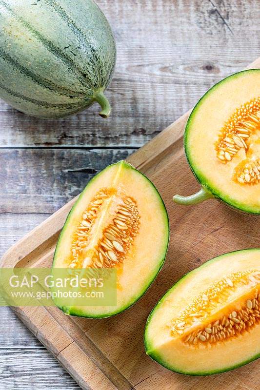 Melon 'Irina' quartered to reveal the fresh and seeds inside