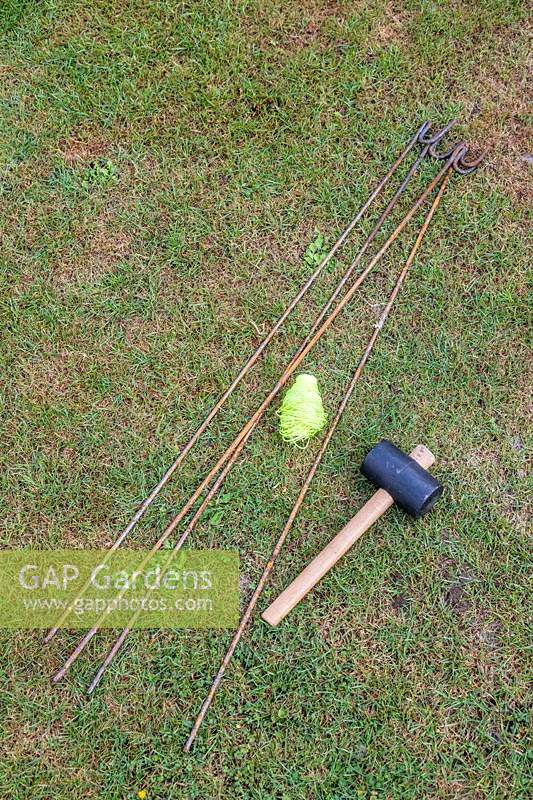 Tools for marking out firepit area including steel fencing pins, string and hammer