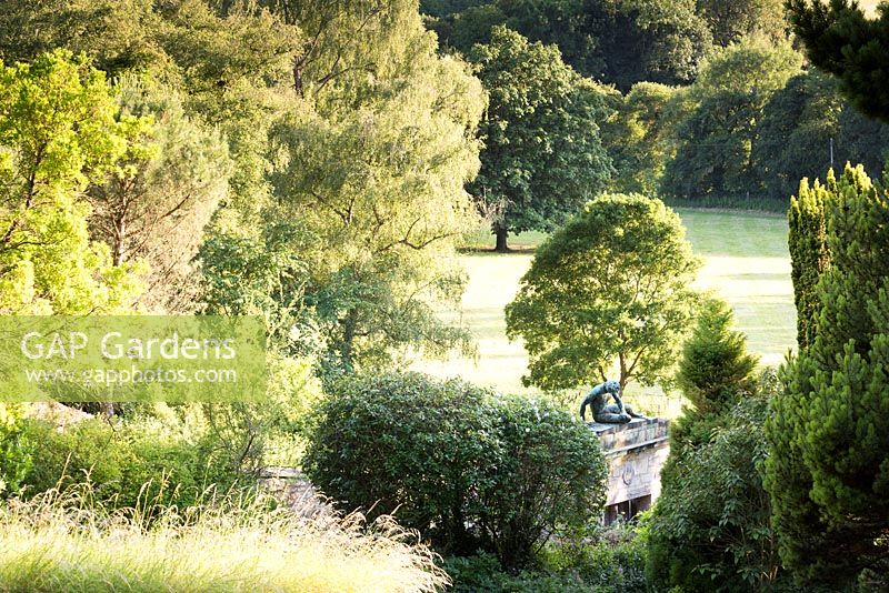 The Dying Gaul sculpture seen from the garden above and framed by greenery 