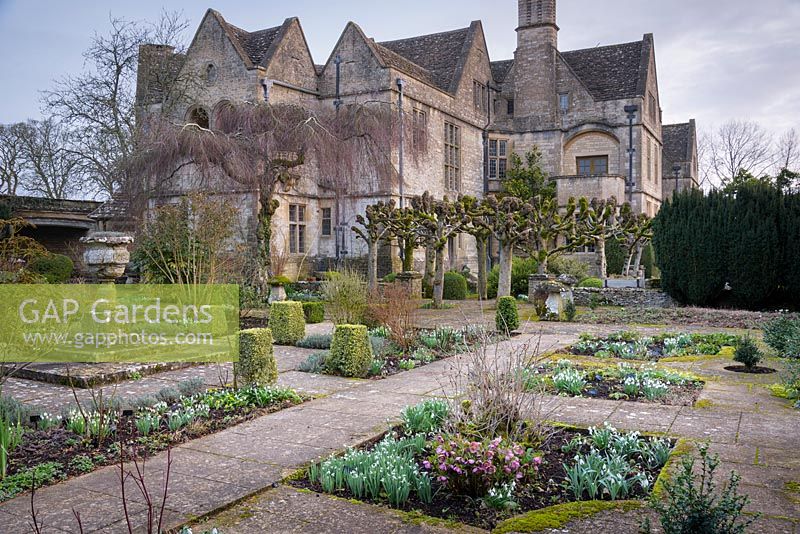 The Leisure Garden with a stone urn and variegated clipped box at its centre, Rodmarton Manor, Glos, UK. 