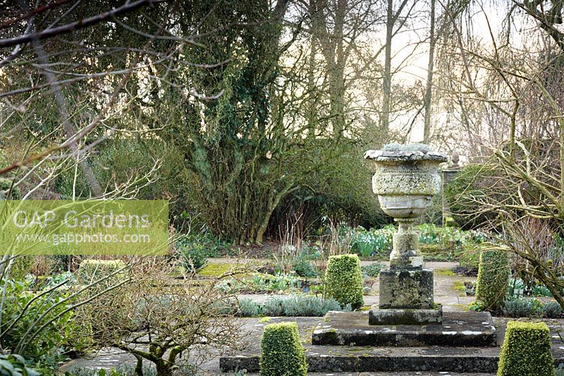 The Leisure Garden with a stone urn and variegated clipped box at its centre, Rodmarton Manor, Glos, UK.

