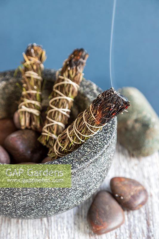 Smudge sticks made with Salvia rosmarinus syn. Rosmarinus officinalis - Rosemary - lit and smoking