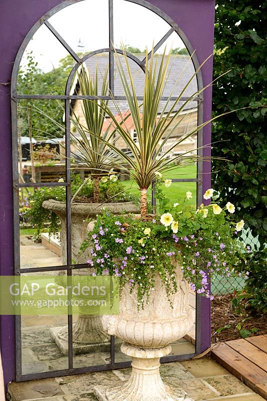 Large arched mirror with urn and mixed planting