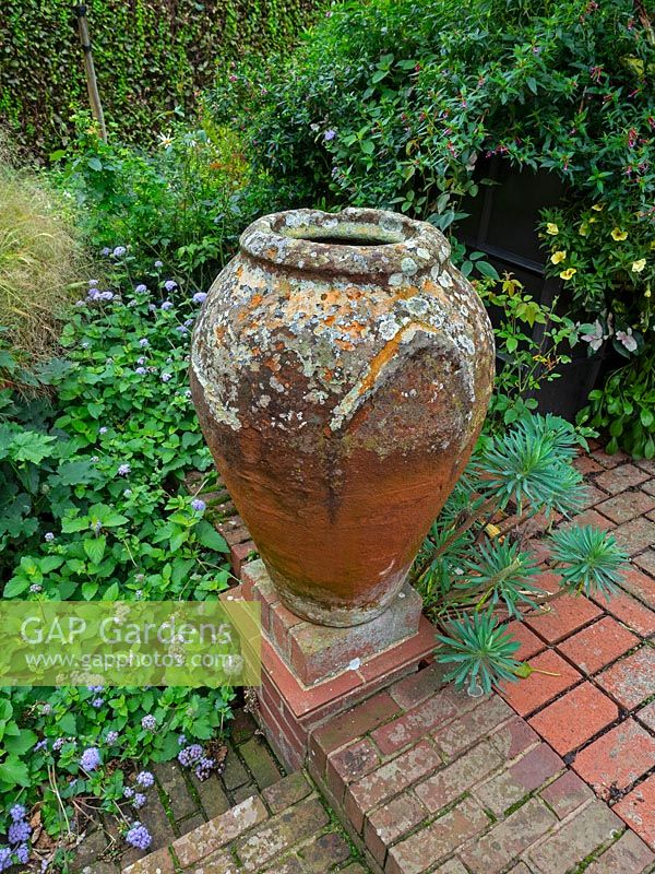 Clay urn and brick path with steps 