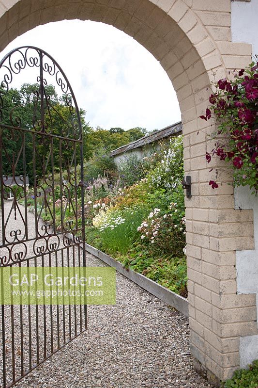 Arched, 'Italian-style' entrance to walled garden. 