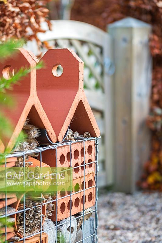 Insect hotel in gabion basket in Autumn