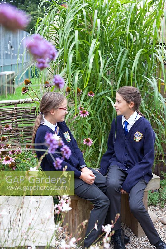 School pupils enjoying the garden at Sedlescombe Primary School, Sussex, UK.
