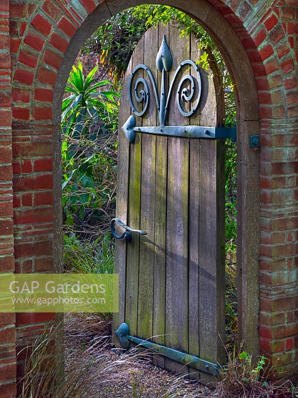 Doorway and arch to the Mediterranean Garden at East Ruston Old Vicarage Gardens, Norfolk, UK. 