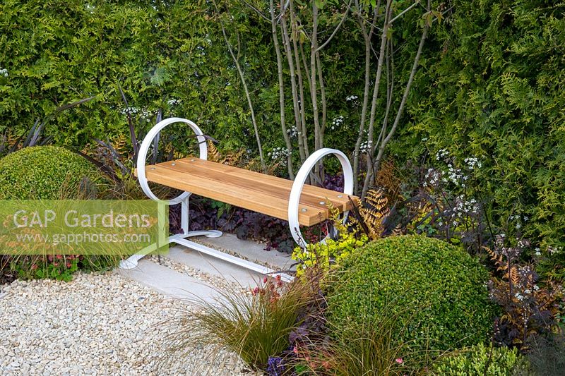 Contemporary wooden garden bench with a gravel path. Time is a Healer garden, RHS Malvern Spring Festival, 2016. Designer Martyn Wilson Associates