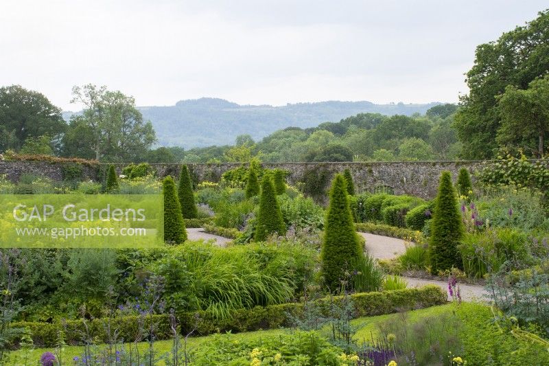 The Upper Walled Garden, overview with countryside beyond - Designer: Penelope Hobhouse - June