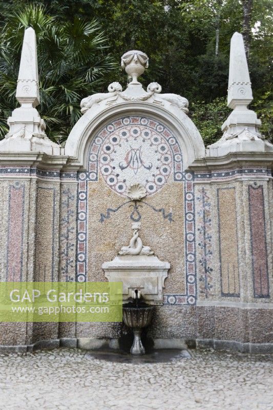 Fountain of Abundance, Sintra, near Lisbon, Portugal, September.  Ornate mosaic and stone Dolphin fountain with shell detail and obelisk.
