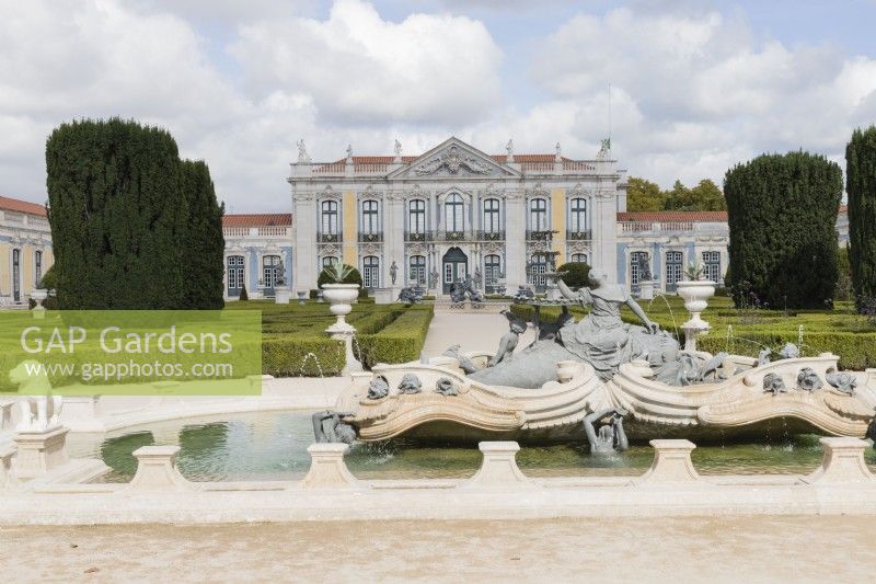 View to the Palace buildings across pool in  the Pensil Garden. Low hedges of Box and statuary. Pool and fountain in foreground. Queluz, Lisbon, Portugal, September. 