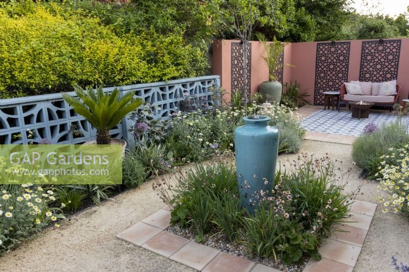 Mediterranean style gravel garden and patio in suburban garden