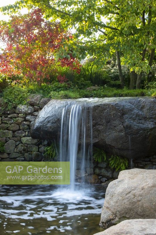  A waterfall and pool in naturalistic garden. Bible Society: The Psalm 23 Garden, Designer: Sarah Eberle, RHS Chelsea Flower Show 2021.
