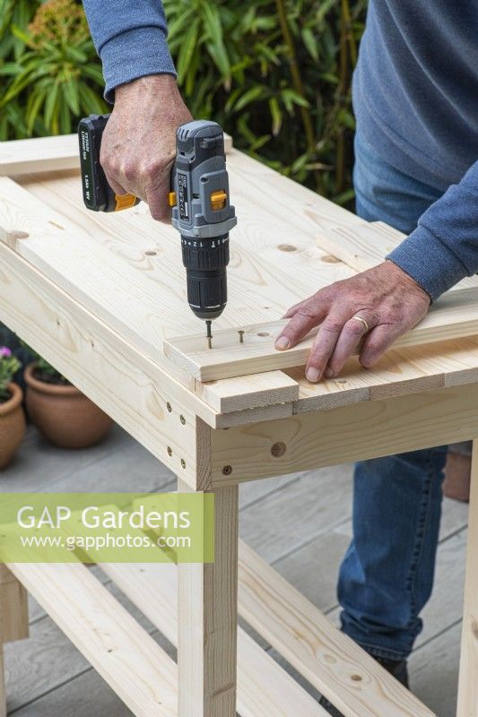 Step-by-Step Making a Potting Bench. Step 11: attach uprights to top rail