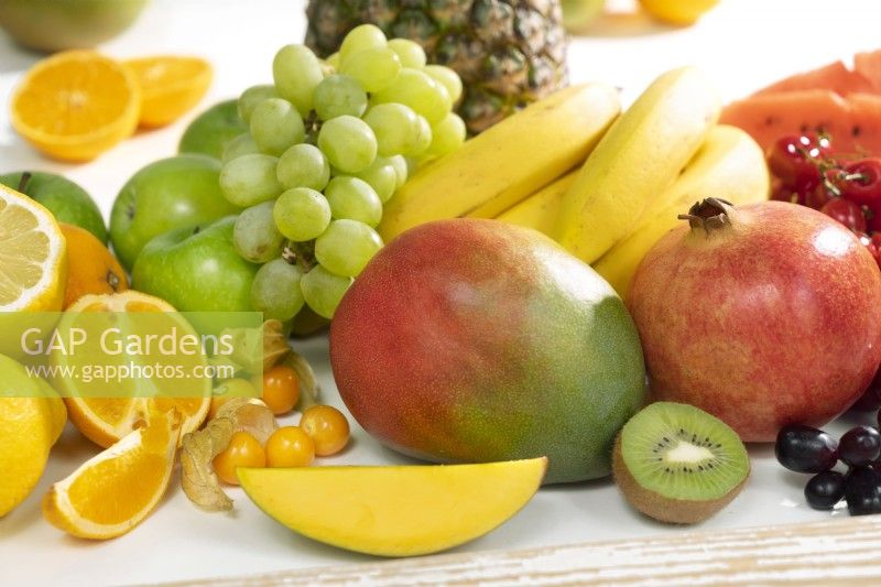 Fruit mix with grapes, mango, bananas and pomegranate, summer June