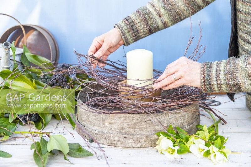 Woman placing birch twigs around the edge of the sieve