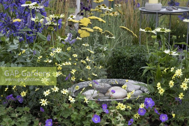 'The Power of Flowers is Everything' at BBC Gardener's World Live 2021 - small water feature amongst blue and yellow perennial planting