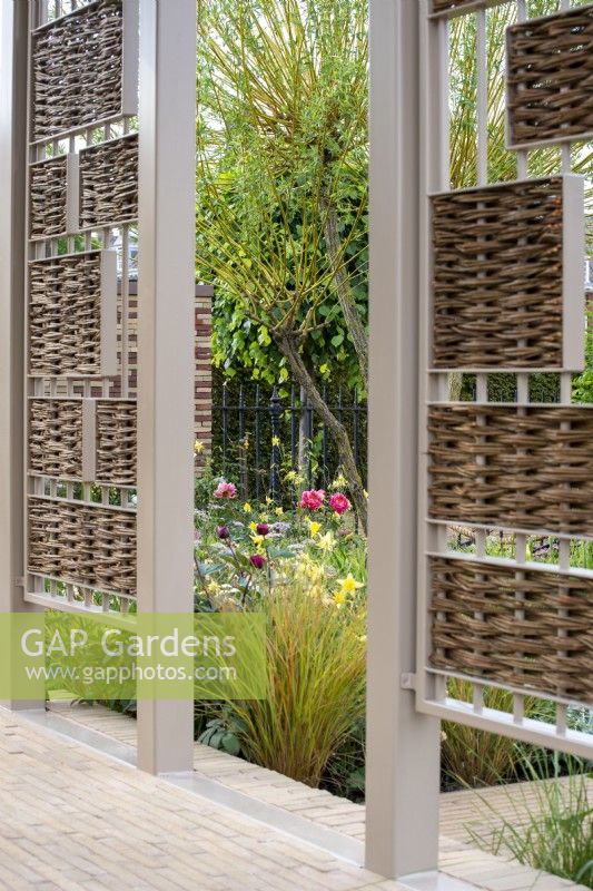 Pavilion with willow inserts gives a view through to border - The Stitcher's Garden, RHS Chelsea Flower Show 2022