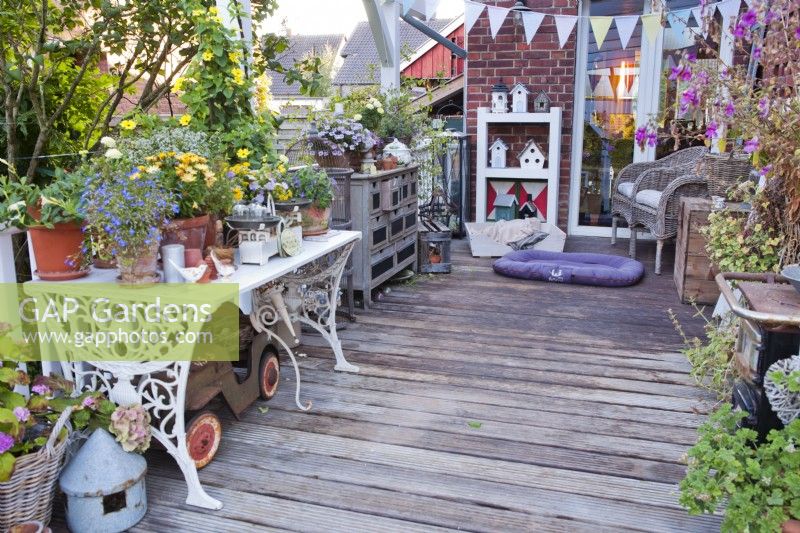Decked patio with decorated tables, bunting and seats.