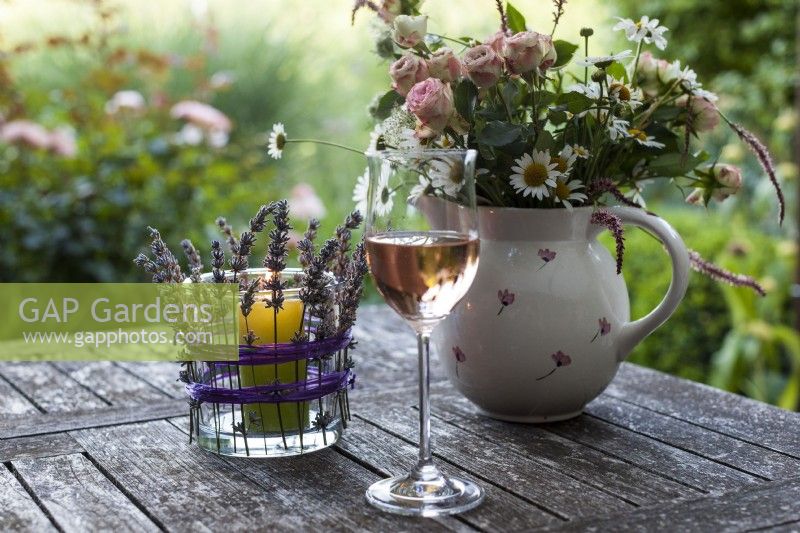 Lavender candle holder, glass of wine and bouquets of summer flowers on a garden table - Step by step How to make a lavender candle holder