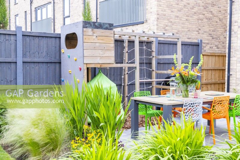 Childrens climbing frame beyond outdoor dining area